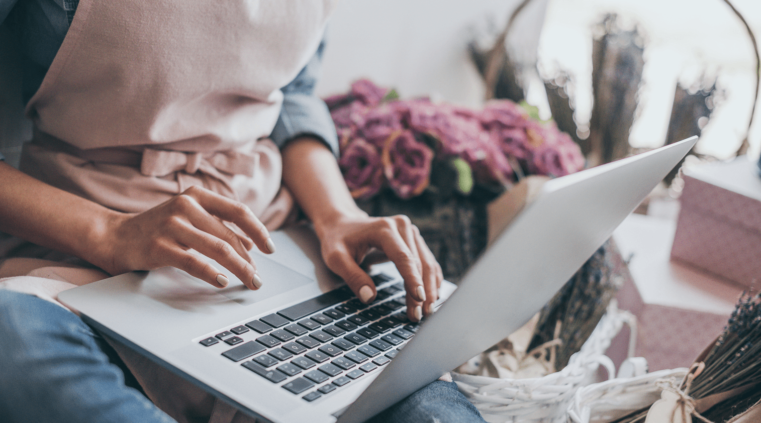 women's hands typing on a laptop